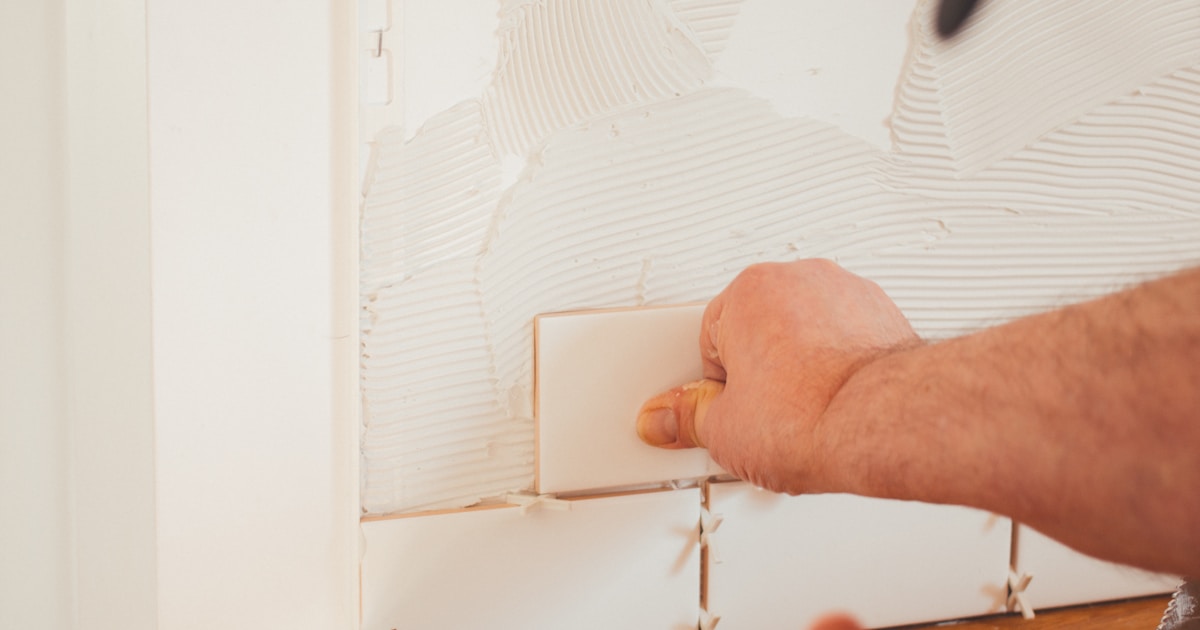 Tiles laid out with measuring tape and calculator